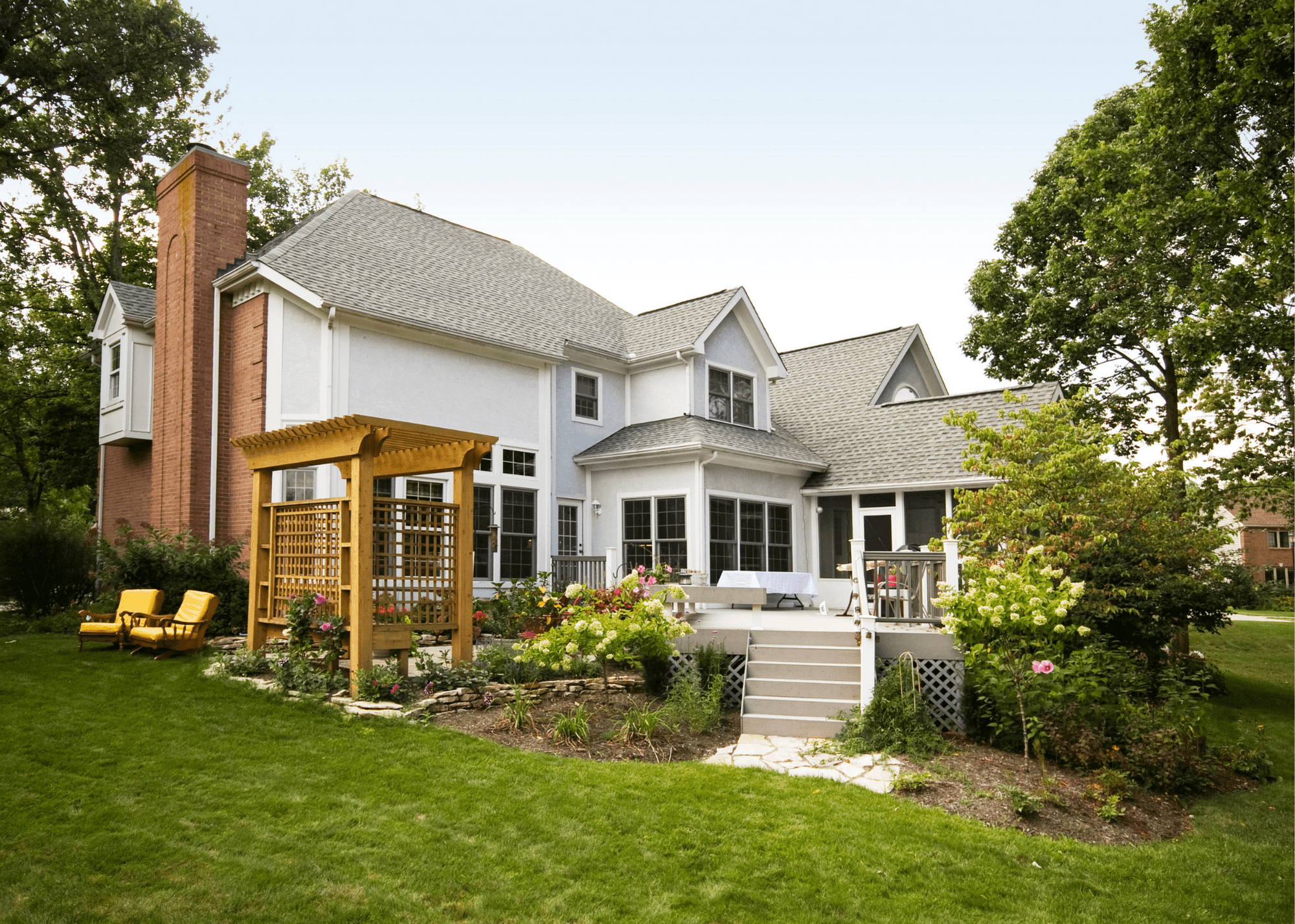 White house backyard with elevated patio